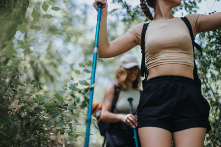 Young women hiking in the forest enjoying a sunny summer dayの写真素材