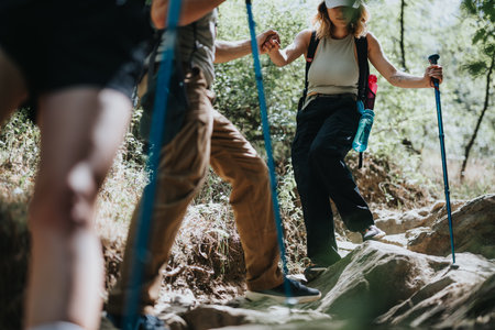 Friends hiking together in a sunny forest, enjoying a healthy and adventurous lifestyleの写真素材