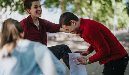 Playful businesspeople laughing and enjoying a friendly outdoor interaction