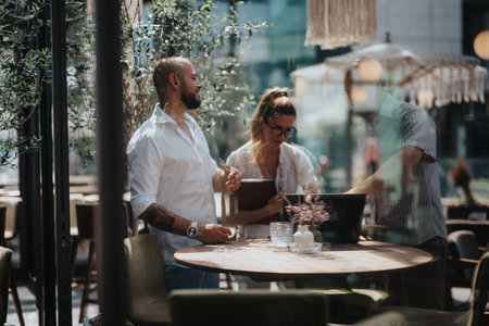 Business workers collaborating and brainstorming ideas at a coffee bar, working remotely and sharing knowledgeの写真素材