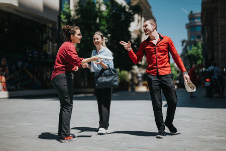 Young businesspeople meeting outdoors and engaging in conversationの写真素材