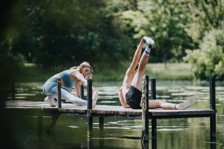 Couple exercising on a wooden bridge surrounded by nature near a serene lake