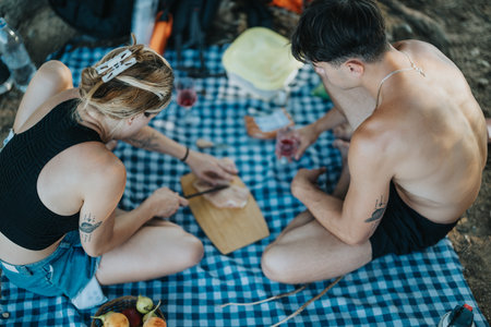 Friends picnic in nature, preparing barbeque and enjoying the outdoorsの写真素材