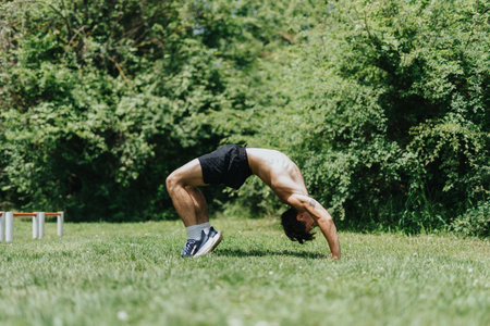 Fit male sports person working out in the park doing exercise