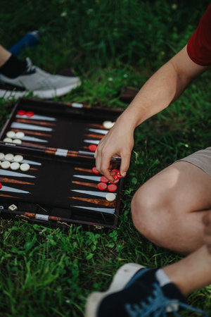 Outdoor backgammon game with friends enjoying leisure timeの写真素材