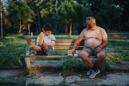 Father and son enjoying a building block game in the parkの写真素材