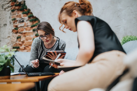 Young business entrepreneurs in outdoor meeting discussing ideas and planning strategiesの写真素材