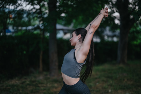 Woman stretching outdoors in peaceful natural setting at dusk