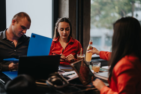 Young business entrepreneurs in a relaxed meeting with laptops and beveragesの写真素材