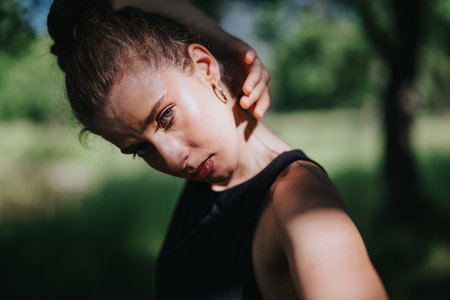Lovely girl dancing in nature, performing modern dance in a serene natural settingの写真素材