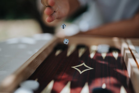 Close-up of dice being rolled onto a backgammon board, capturing moment of chance and anticipation...