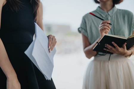 Close-up of businesswomen discussing financial planning and marketing strategy in an informal meeting settingの写真素材