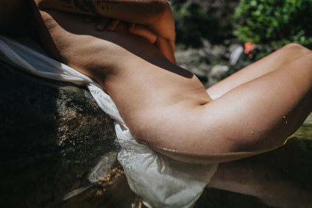 Relaxation in nature by the water with body partially submergedの写真素材