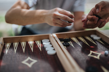 Close-up of people playing backgammon outdoors on a sunny dayの写真素材