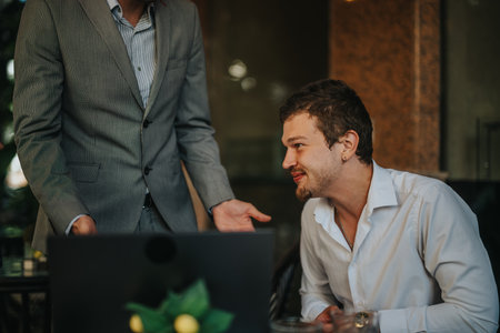 Business professionals engaged in a dynamic meeting discussing sales strategies and analyzing growth reportsの写真素材