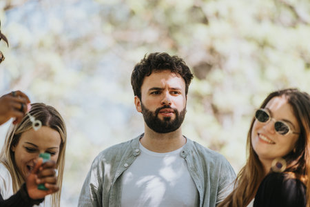 Group of joyful multiracial friends enjoying a sunny day in the park togetherの写真素材