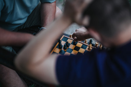 Intense chess match between friends in a strategic outdoor settingの写真素材