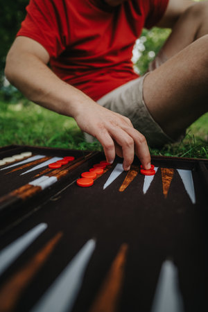 Person playing backgammon outdoors on a sunny dayの写真素材