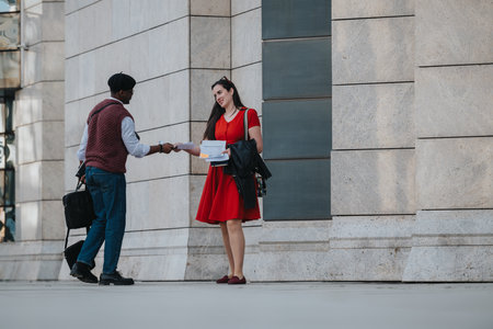 Business associates engaged in a discussion outdoors in the cityの写真素材