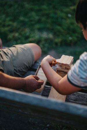 Father and son enjoying a building blocks game in the parkの写真素材