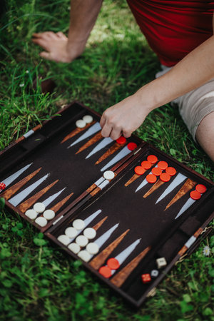 Close-up of a backgammon game being played outdoors on grassの写真素材