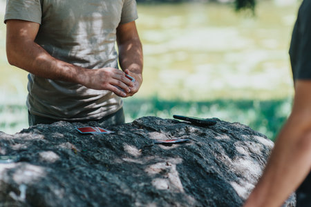 Man playing cards outdoors on a sunny day in the parkの写真素材