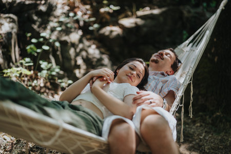 Couple relaxing in a hammock outdoors enjoying a peaceful summer dayの写真素材