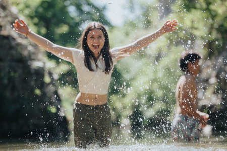 Young people enjoying a carefree day splashing in the water outdoors