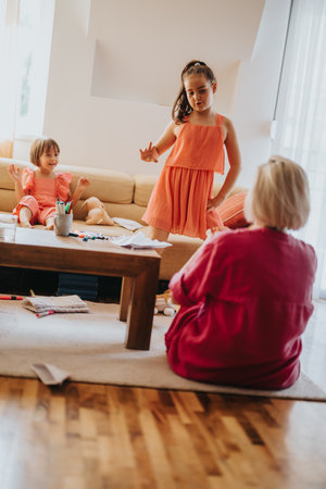 Playful children interacting in a cozy living room setting with familyの写真素材