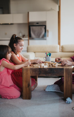 Children playing an educational board game in the cozy living roomの写真素材