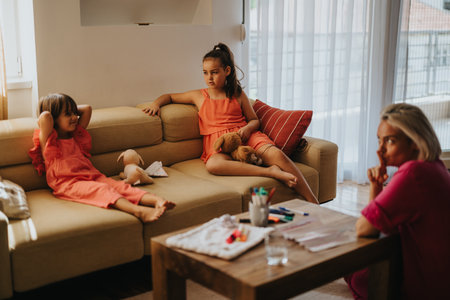 Family bonding time with children relaxing in cozy living roomの写真素材