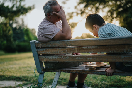 Father and son bonding with building blocks in the parkの写真素材