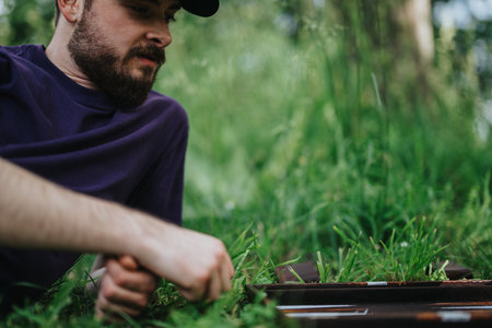 Man relaxing outdoors in nature playing backgammon on a sunny day