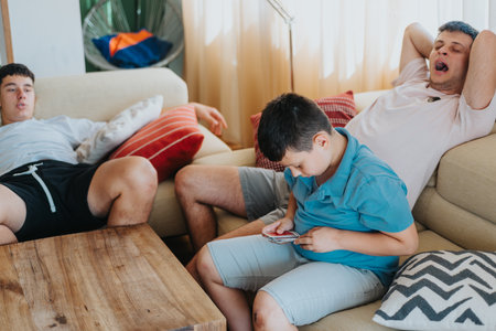 Family playing cards and relaxing at home together on a cozy afternoonの写真素材