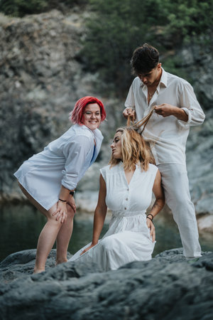 Friends having fun in nature with creative styling and playful expressionsの写真素材