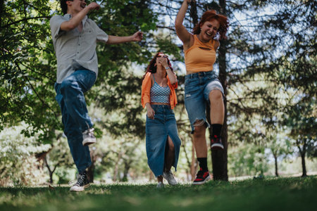 Young teenagers having fun in the park showcasing friendship, joy and moments of laughterの写真素材