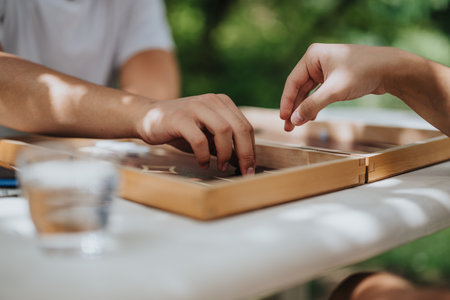 Two people playing a board game in natural outdoor settingの写真素材