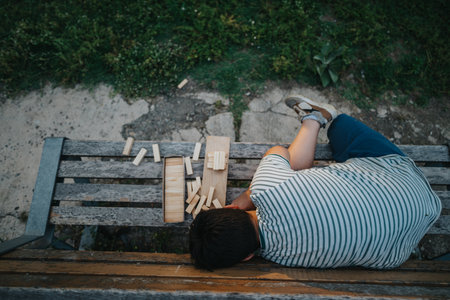 Young boy enjoying building blocks game in the park outdoorsの写真素材
