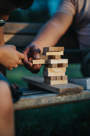 Father and son bonding while playing building blocks in the parkの写真素材