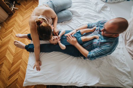 Happy family spending quality time with their baby at homeの写真素材