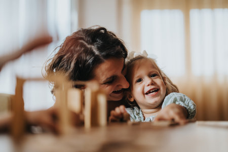 Mother and daughter sharing a joyful moment at home togetherの写真素材