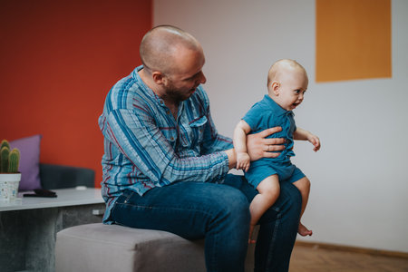 Father bonding with baby son in cozy living roomの写真素材