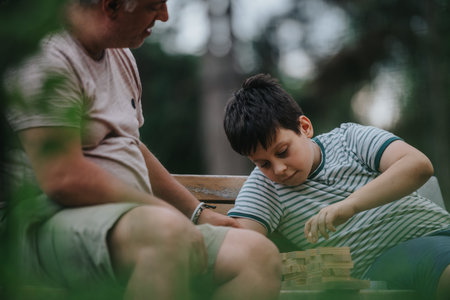 Father and son playing building block games together in the park