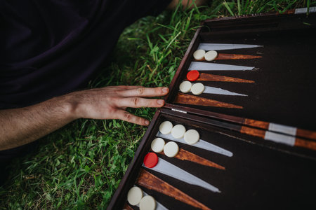 Relaxing outdoor backgammon game on a grassy lawnの写真素材
