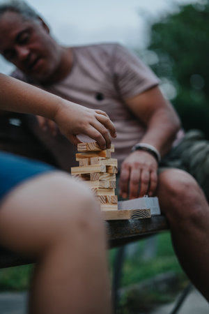 Father and son enjoying a building blocks game in the parkの写真素材
