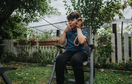Young girl engaging with snakes in a lush garden setting outdoors