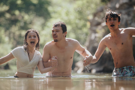 Group of friends enjoying a fun day at the riverの写真素材