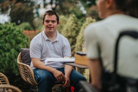 Boy with Down syndrome playing cards with girl in wheelchairの写真素材