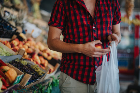 Friends shopping for fresh produce at a local greengrocer marketの写真素材