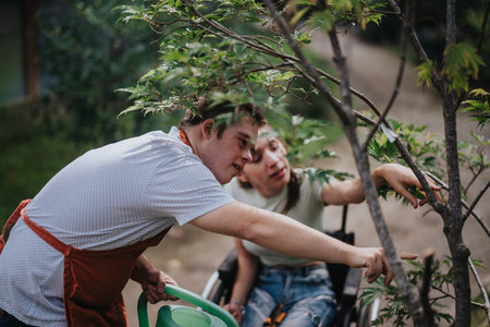Young people enjoying gardening together outside on a sunny dayの写真素材